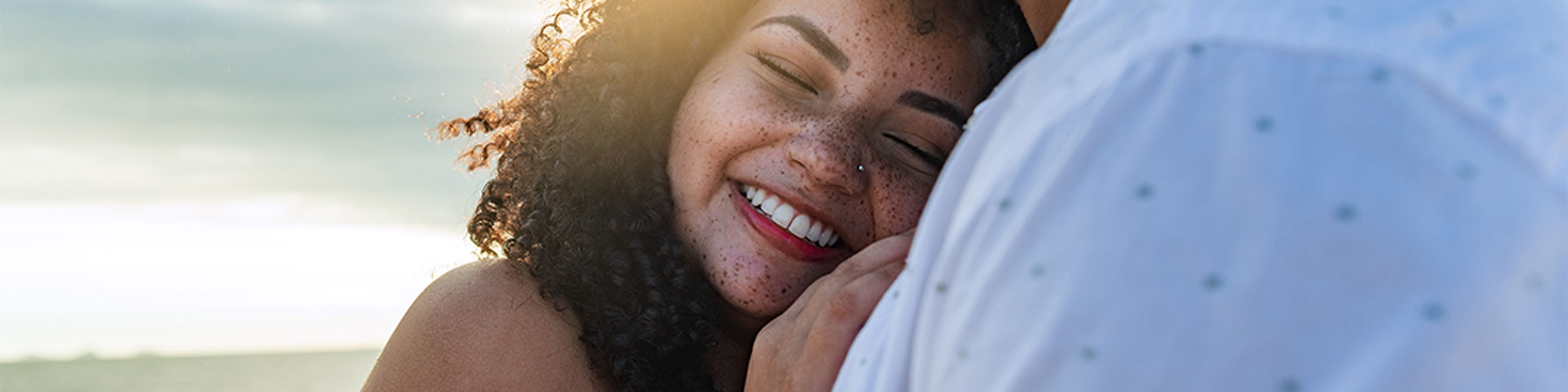 Woman smiling and hugging a man