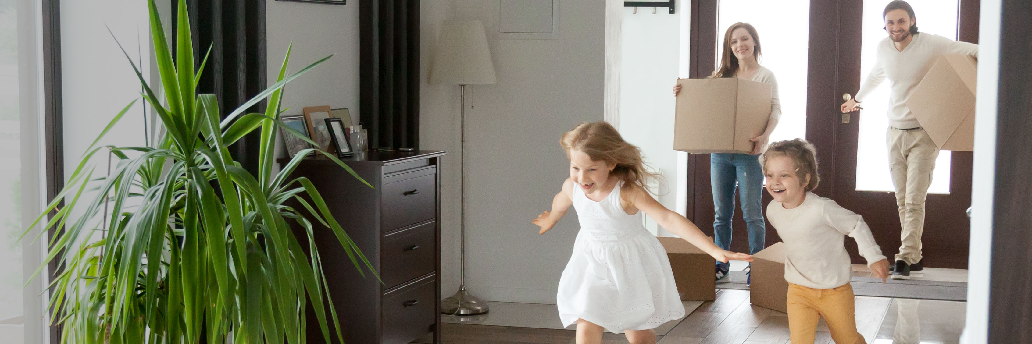 Family in living room with moving boxes