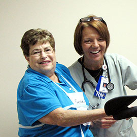 Heart patient Geraldine Leka has a laugh with Cindy Batz during a cardiac rehab Phase III session at Spectrum of St. Mary Medical Center.