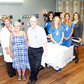 Highland resident Liz Breslin and her husband, John, with the Community Hospital stroke team.
