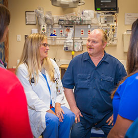 Stroke survivor Virgil Powell with just part of his care team of doctors, nurses and physical therapists at St. Catherine Hospital.