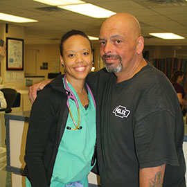 Emergency Services physician Katrina Mattingly, MD, is pictured with Luis Romero. Since recovering from a stroke and life-threatening heart condition, Romero has returned to St. Catherine Hospital for a visit every year.