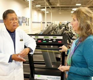 Cardiopulmonary rehabilitation patient Deb Shurr discusses her progress in the Phase 2 program at Spectrum of St. Mary Medical Center with the program director, Felix Gozo, MD.