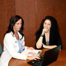Teacher Katie Oberman, right, learned to view food as fuel with help from the Healthy 4 Life team, including bariatric care coordinator Lisa Almaraz. Here at the monthly check-in appointment, they discuss total weight loss since surgery and review current medications.