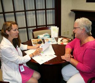 Oncology nurse navigator Nicole Bryner meets with Carol Schaap to review her survivorship plan after breast cancer.
