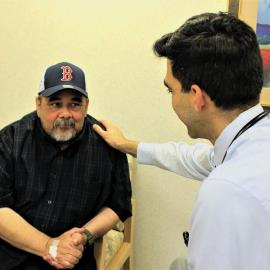 Gilberto Lopez consults with oncologist Amer Sidani, MD, on the progress of his chemotherapy at St. Catherine Hospital.